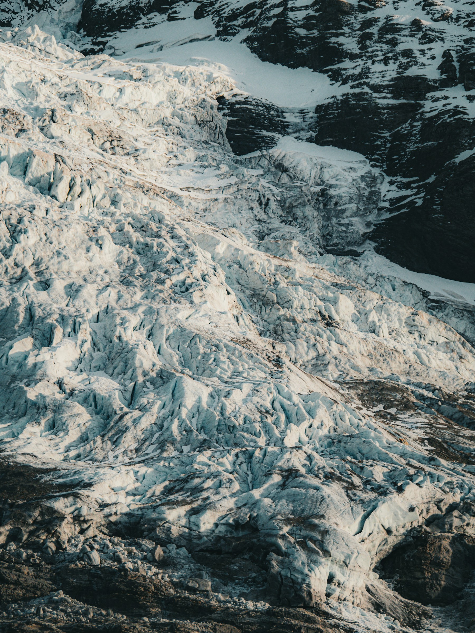 Snow and exposed rock across an alpine landscape